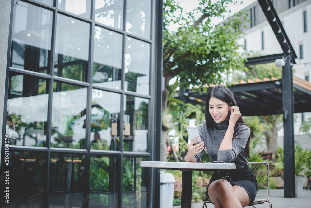 Portrait of young businesswoman use mobile phone while sitting in comfortable coffee shop during work break, charming happy female reading fashion news on cell telephone