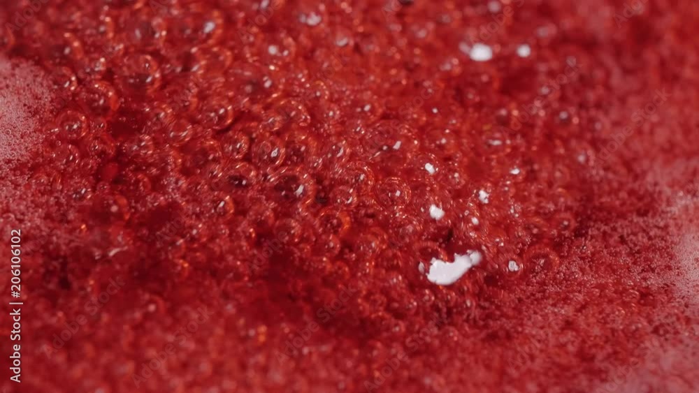 Red cranberries marmalade boiling, close up macro. Red cranberries marmalade boiling, close up macro.