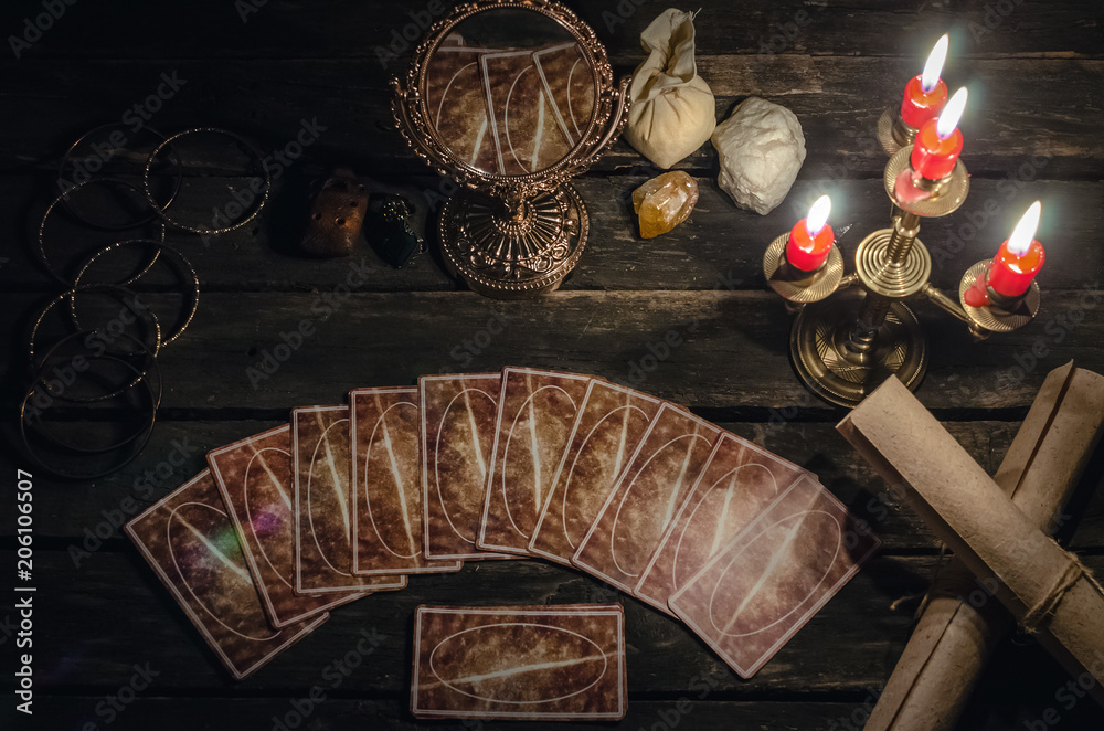 Tarot cards on fortune teller desk table background. Futune reading  concept. Magic mirror on paranormal table. Photos | Adobe Stock