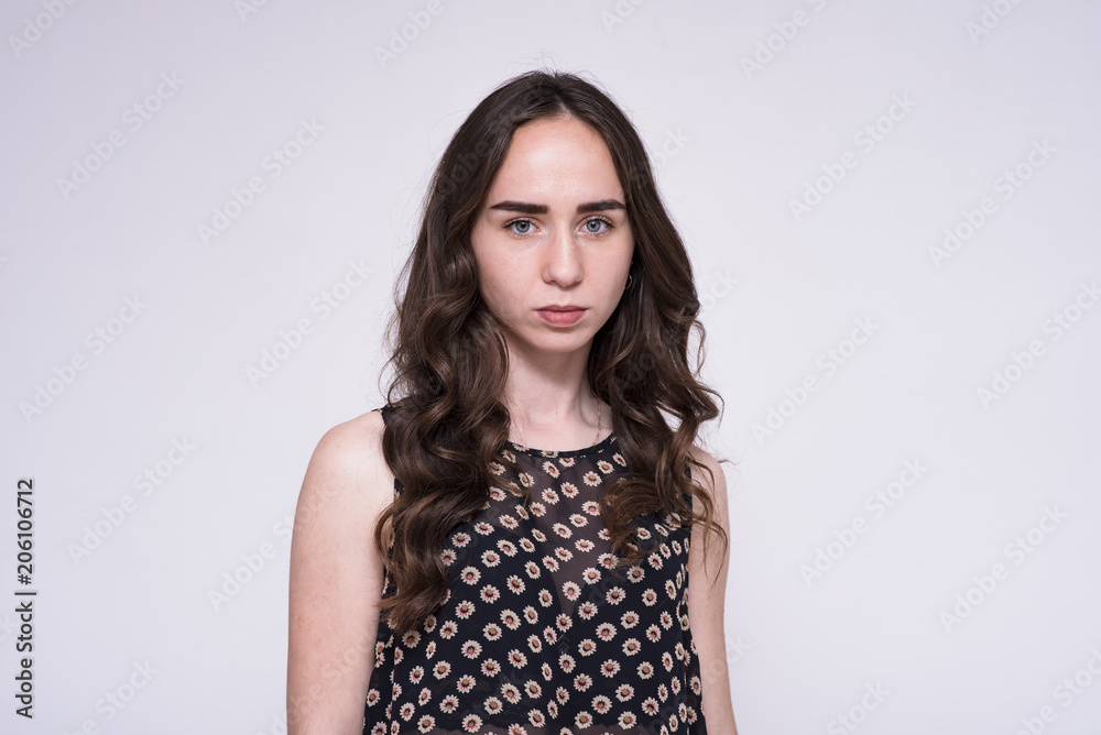 portrait of young beautiful brunette girl on white background showing different emotions in different poses. portrait of young beautiful brunette girl on white background showing different emotions in different poses.