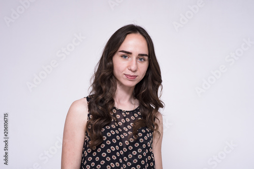 portrait of young beautiful brunette girl on white background showing different emotions in different poses. photo