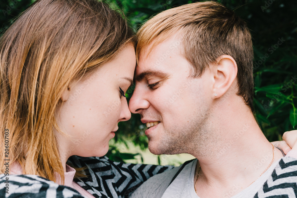 Two lovers walk around the park, kiss and hug, a love story. Two lovers walk around the park, kiss and hug, a love story.