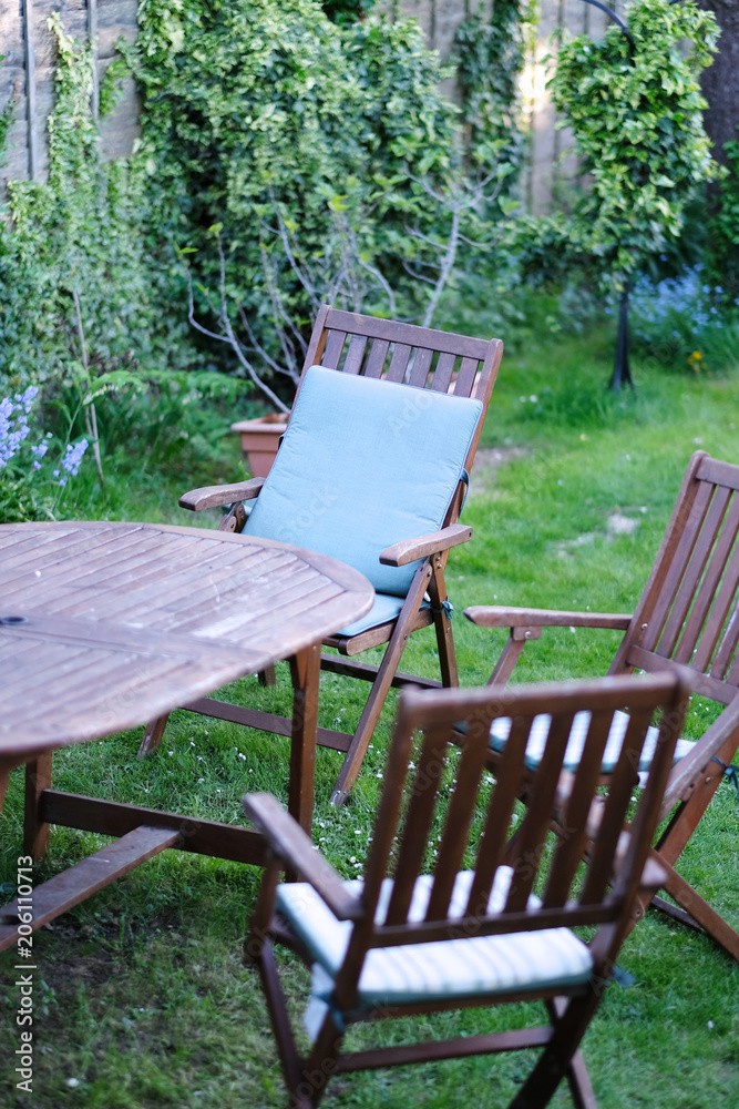 A set of garden wooden folding furniture on the lawn in the garden A set of garden wooden folding furniture on the lawn in the garden