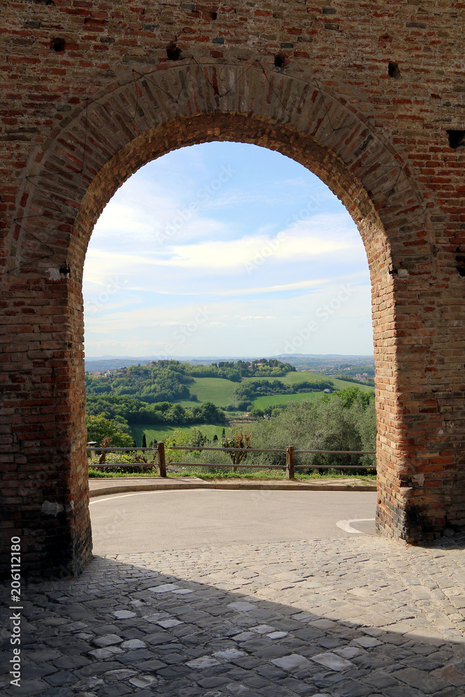 Gradara, Marche, Italy, May 2018. Countryside of central Italy view from an arch of the medieval walls of the village.