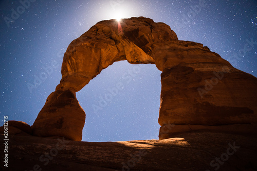 Delicate Arch in Arches National Park, Utah under a full moon and stars. 