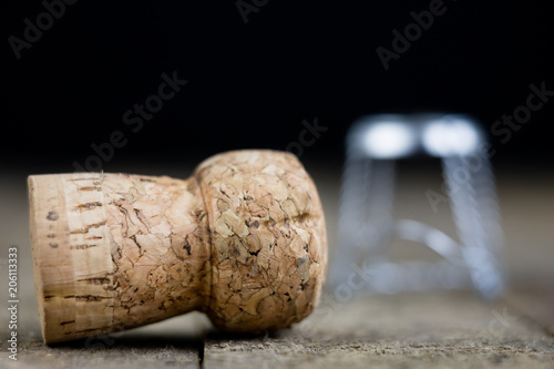 Cork from champagne on a wooden kitchen table. Good New Year's drinks and great fun.