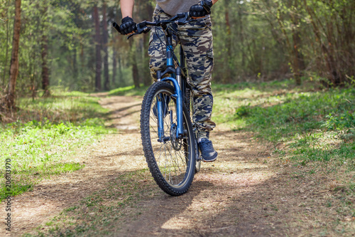A man on a bike riding on a forest trail