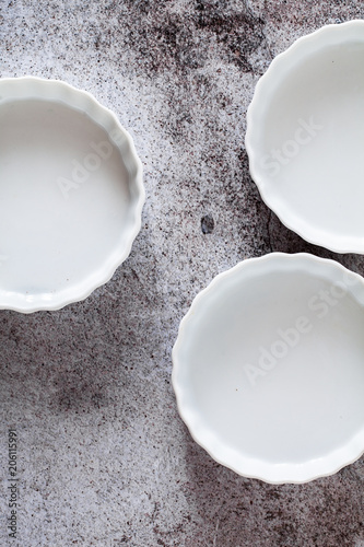 ceramic molds for baking tartlets on a gray stone table