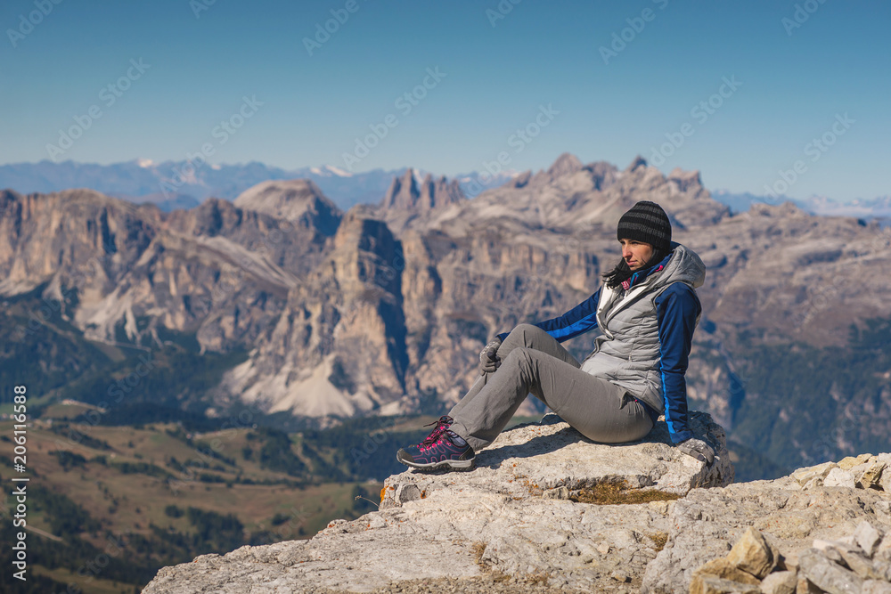 pretty young woman watching the beauty of nature in south tyrol, passo falzarego, italien dolomites