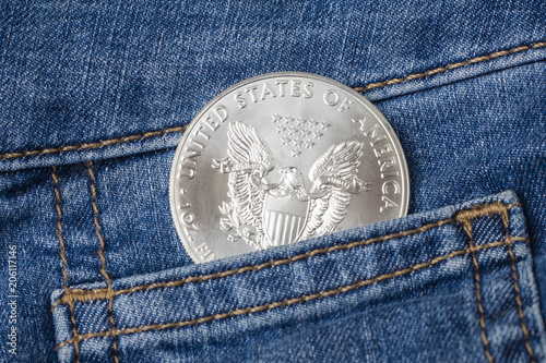 Silver Eagle Coin in your jeans pocket. American Silver Eagle, circa photo