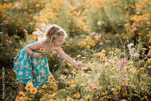 Girl in meadow full of flowers