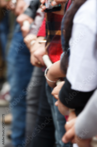 blur image of various people pulling rope together, closeup of hands. Teamwork. Unity concept. Selective focus