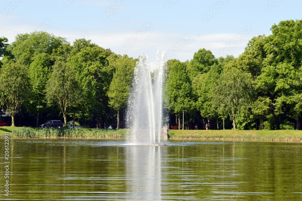 natural lake with fountain in the middle