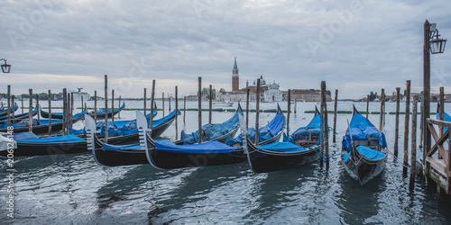 ondolas moored by Saint Mark square with San Giorgio di Maggiore church in Venice