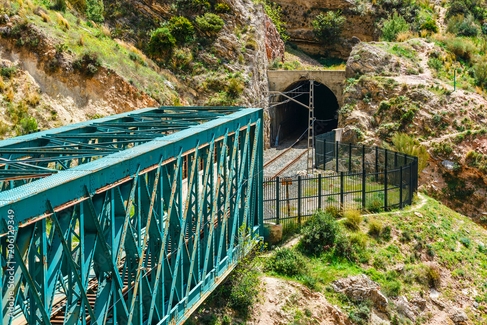 Fototapeta premium El Caminito del Rey with train iron bridge in Malaga, Spain. End of the tourist trail