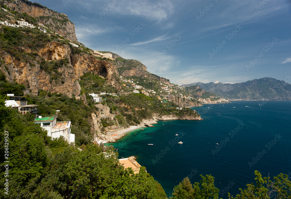 View of Houses at the Amalfi Coast close to the City of Amalfi with turquoise Water on a sunny Day