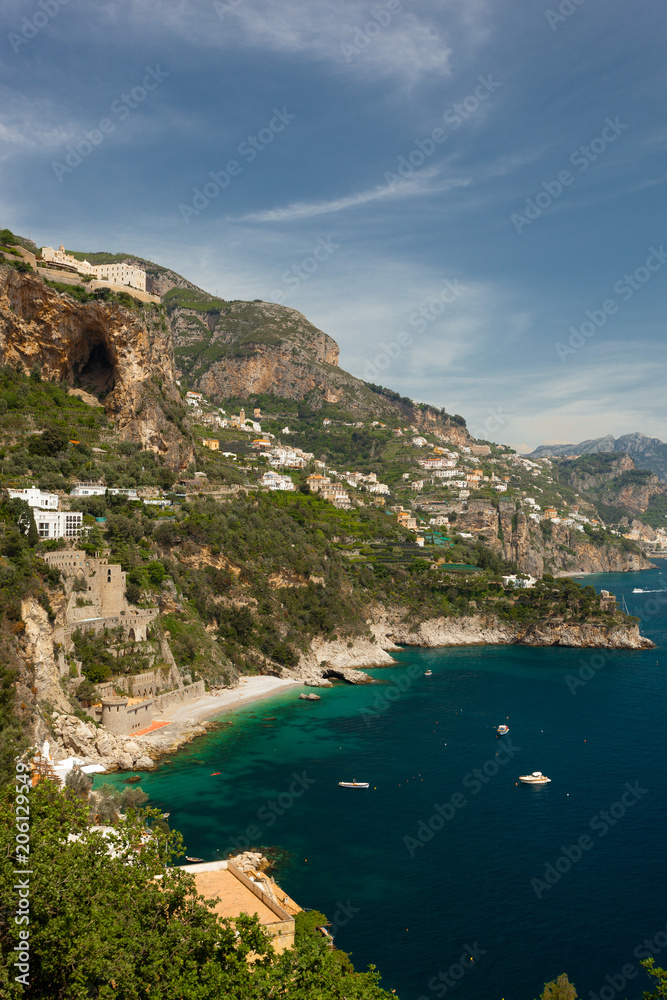 View of Houses at the Amalfi Coast close to the City of Amalfi with turquoise Water on a sunny Day