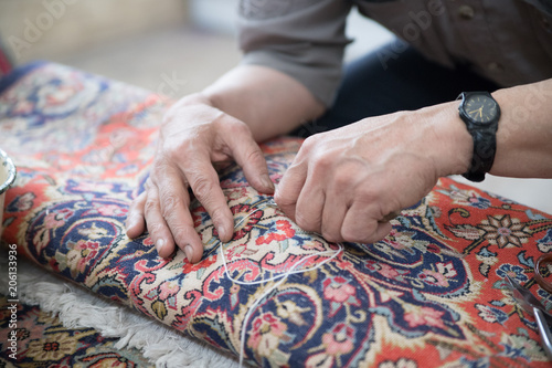 Man repairing a carpet