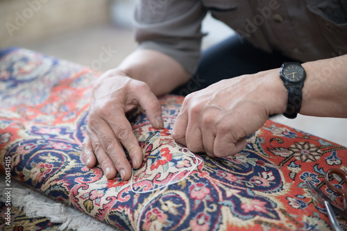 Man repairing a carpet