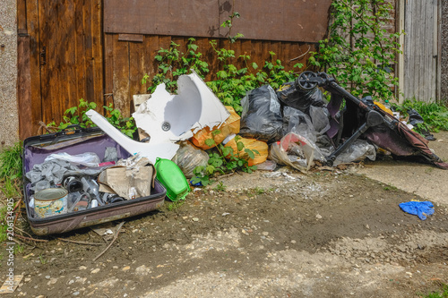 Pile of rubbish, rotting after being fly tipped and left in an urban alleyway.  Demonstrates anti-social behaviour.