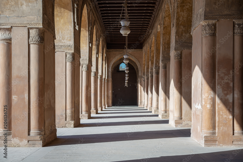 One of the passages surrounding  the courtyard of the Mosque of Ahmad Ibn Tulun framed by huge decorated arches, old Cairo, Egypt