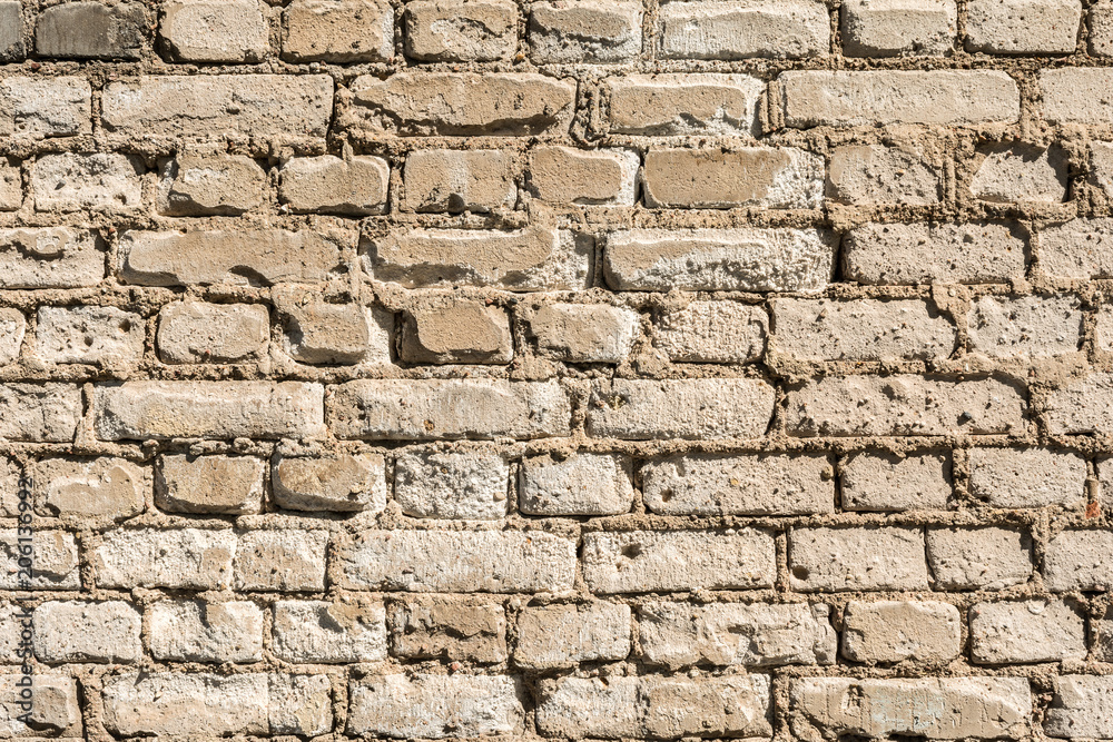 Fototapeta premium texture of the old wall of brick blocks, scattered brick and brickwork, architecture abstract background
