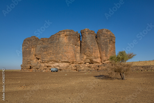 Camp with 4x4 expedition verhicle at massive rock formation – Mauritania