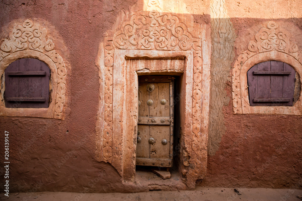 Famous ancient arabic door paintings at medieval bricked house in World Heritage Site Walata, Mauritania