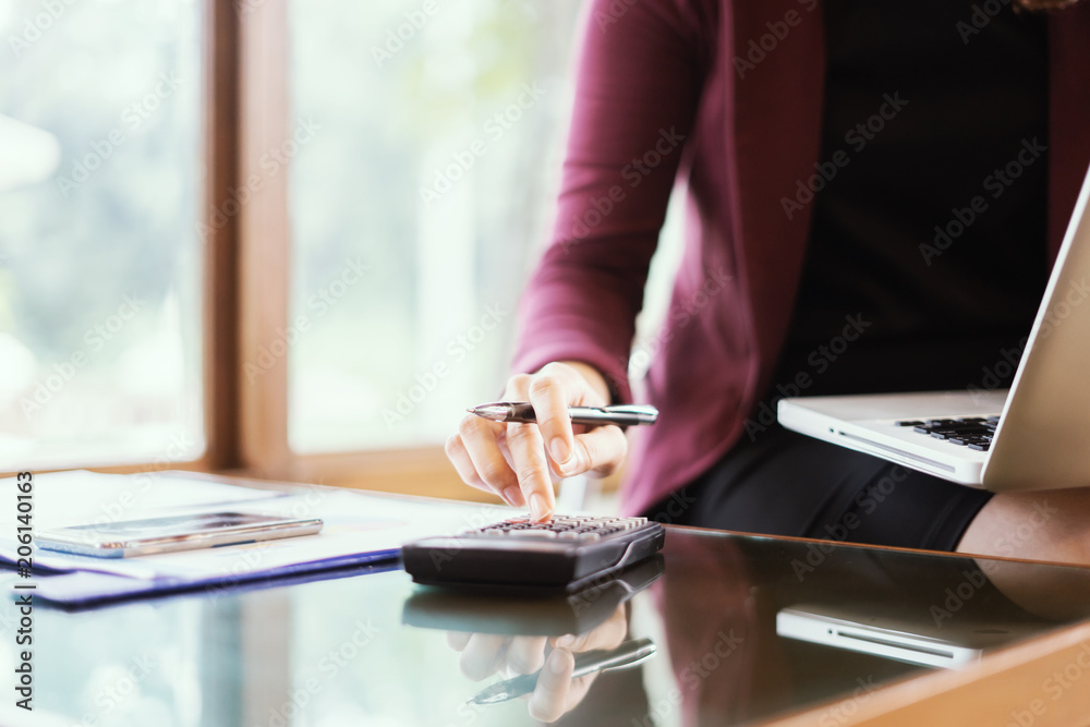 Fototapeta premium calculate,finance,accounting,Business people analyzing investment charts with calculator .Accounting technology,using laptop at office,Analyze plans document paper graph chart business marketing plan.