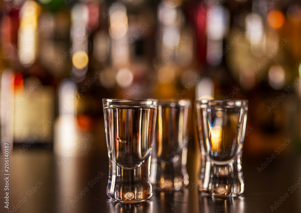 Traditional pure vodka in glasses on a black background, chilled drink