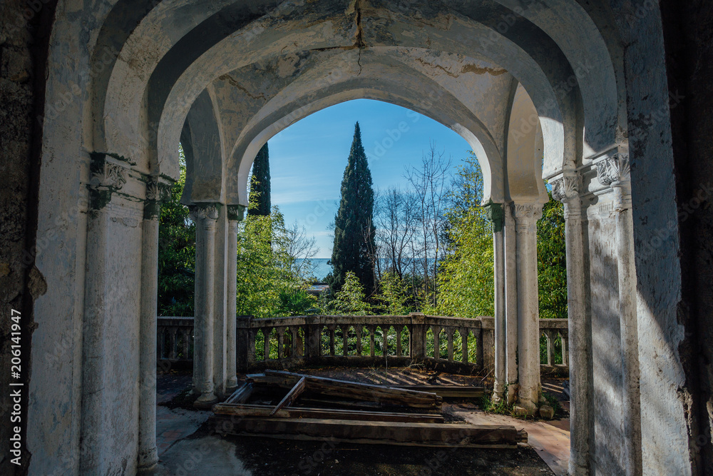 Old abandoned mansion. Balcony with columns and beautiful view to the park and black sea