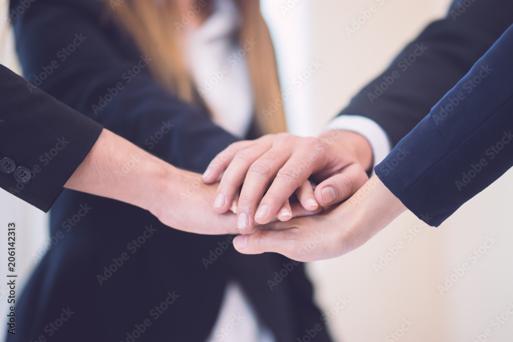 Teamwork concept,Business team standing hands together Teamwork concept,Business team standing hands together