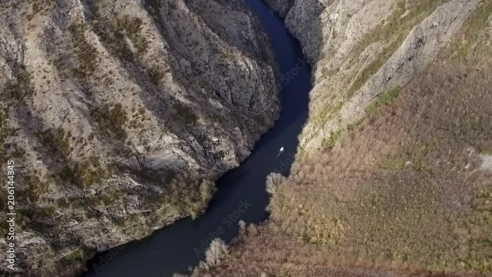 Aerial looking down at boat on a river in a canyon. Lake Matka, Macedonia Aerial looking down at boat on a river in a canyon. Lake Matka, Macedonia