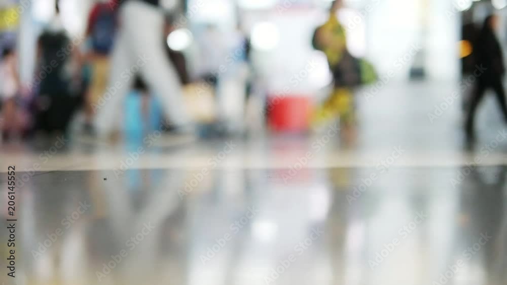 Slow motion blur people or tourist or passenger walking at airport terminal - background rush travel people in airport concept Slow motion blur people or tourist or passenger walking at airport terminal - background rush travel people in airport concept
