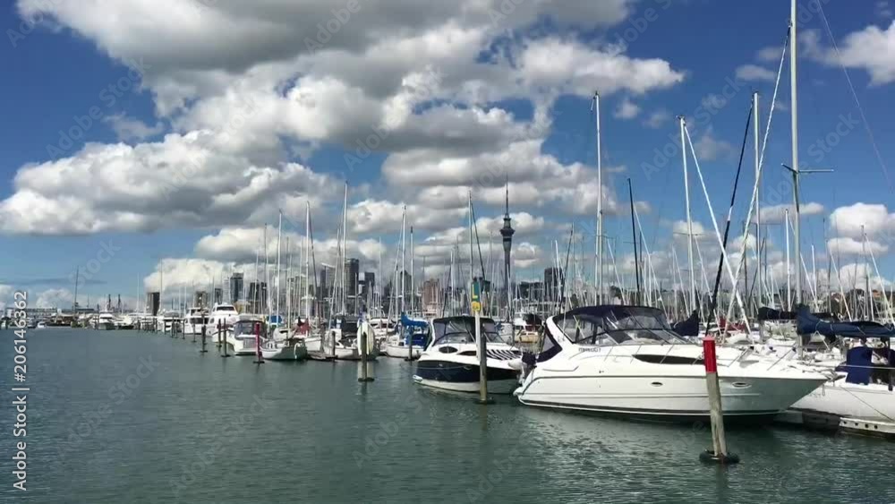 Time lapse of Yacht sails in Westhaven Marina against Auckland skyline.Westhaven Marina, the largest marina in the Southern Hemisphere Time lapse of Yacht sails in Westhaven Marina against Auckland skyline.Westhaven Marina, the largest marina in the Southern Hemisphere