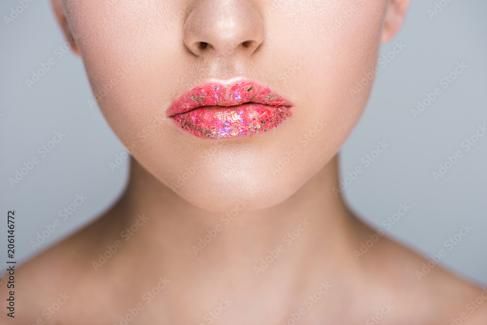 Obraz premium cropped image of woman with glitter on lips isolated on grey