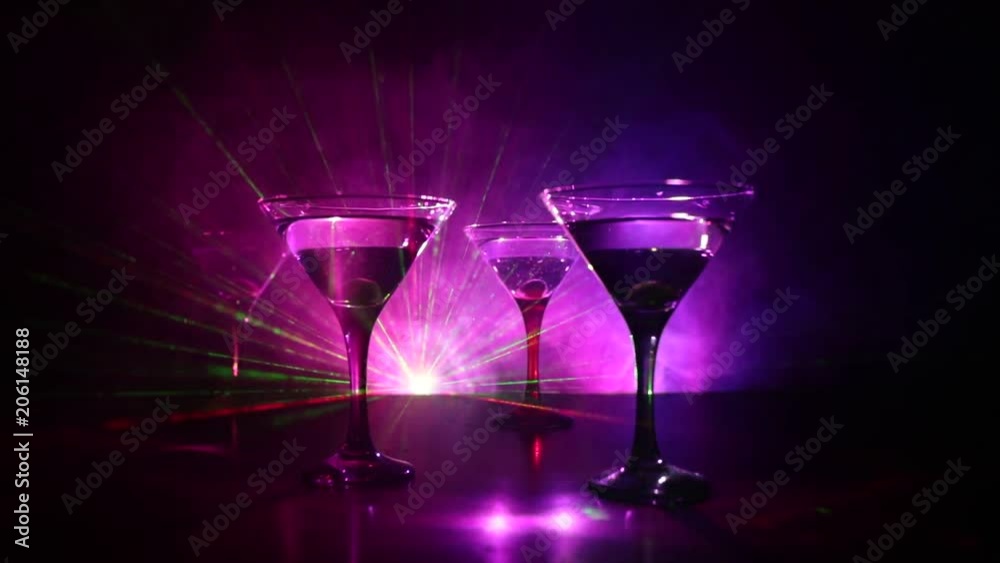 Video Stock Alcohol drink poured into martini glasses of bottle