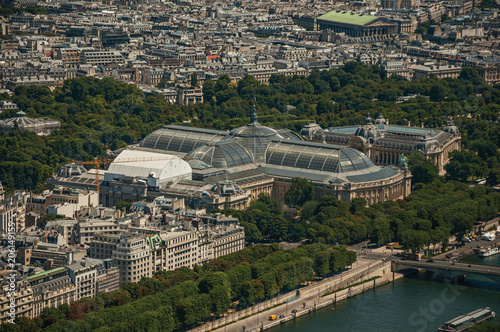 Grand and Petit Palais with greenery in a sunny day, seen from the Eiffel Tower top in Paris. Known as the “City of Light”, is one of the most impressive world’s cultural center. Northern France.