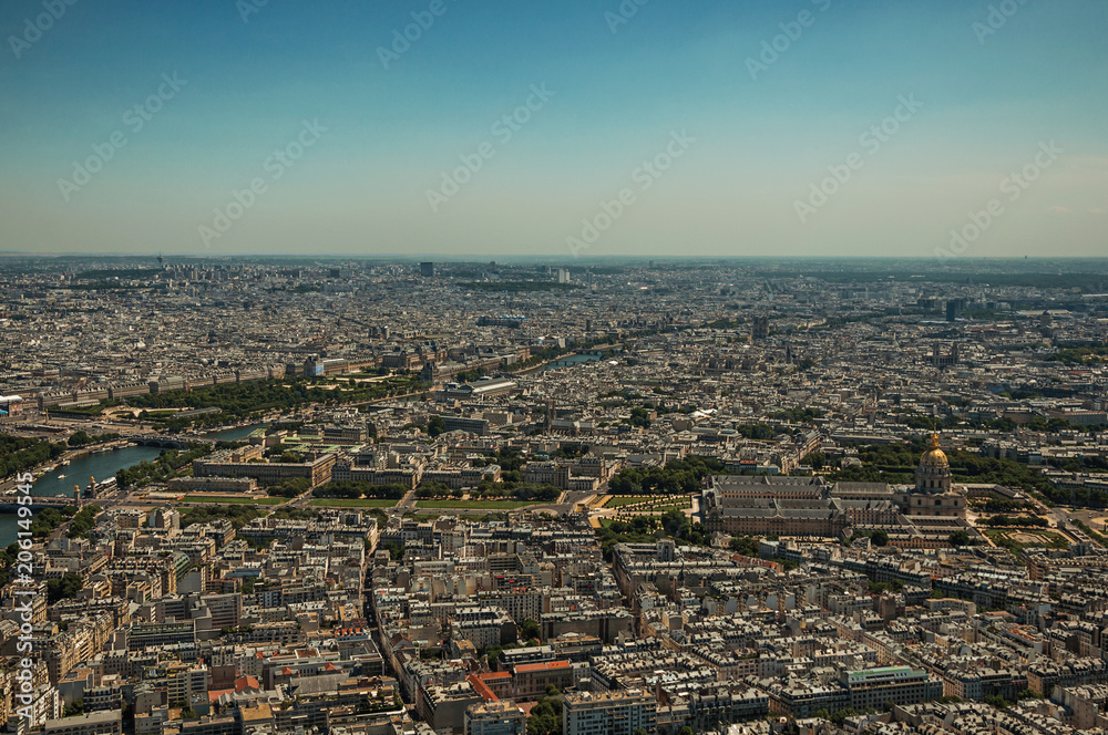 Skyline, buildings and Les Invalides dome in a sunny day, seen from the Eiffel Tower top in Paris. Known as the “City of Light”, is one of the most impressive world’s cultural center. Northern France.