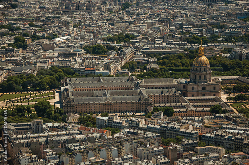 Greenery, buildings and Les Invalides dome in a sunny day, seen from the Eiffel Tower top in Paris. Known as the “City of Light”, is one of the most impressive world’s cultural center. Northern France