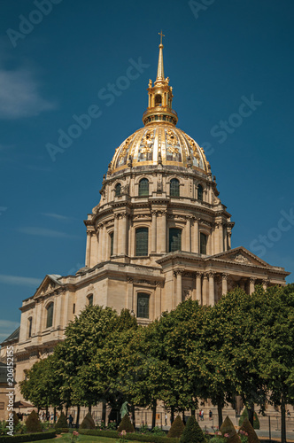 Trees in the gardens of Les Invalides Palace with the golden dome in a sunny day at Paris. Known as the “City of Light”, is one of the most impressive world’s cultural center. Northern France.