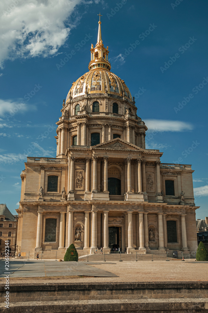 Front facade of Les Invalides Palace with the golden dome in a sunny day and blue sky at Paris. Known as the “City of Light”, is one of the most impressive world’s cultural center. Northern France.