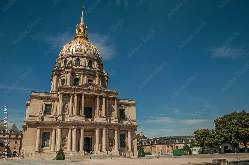 Front facade of Les Invalides Palace with the golden dome in a sunny day and blue sky at Paris. Known as the “City of Light”, is one of the most impressive world’s cultural center. Northern France.