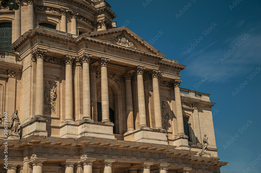 Close-up of the Neoclassical facade of Les Invalides Palace in a sunny day and blue sky at Paris. Known as the “City of Light”, is one of the most impressive world’s cultural center. Northern France.