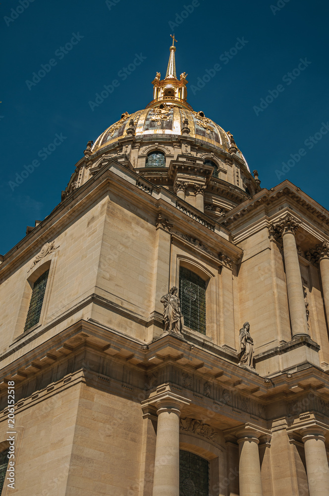 Close-up of the facade and golden dome of Les Invalides Palace with a sunny blue sky at Paris. Known as the “City of Light”, is one of the most impressive world’s cultural center. Northern France.