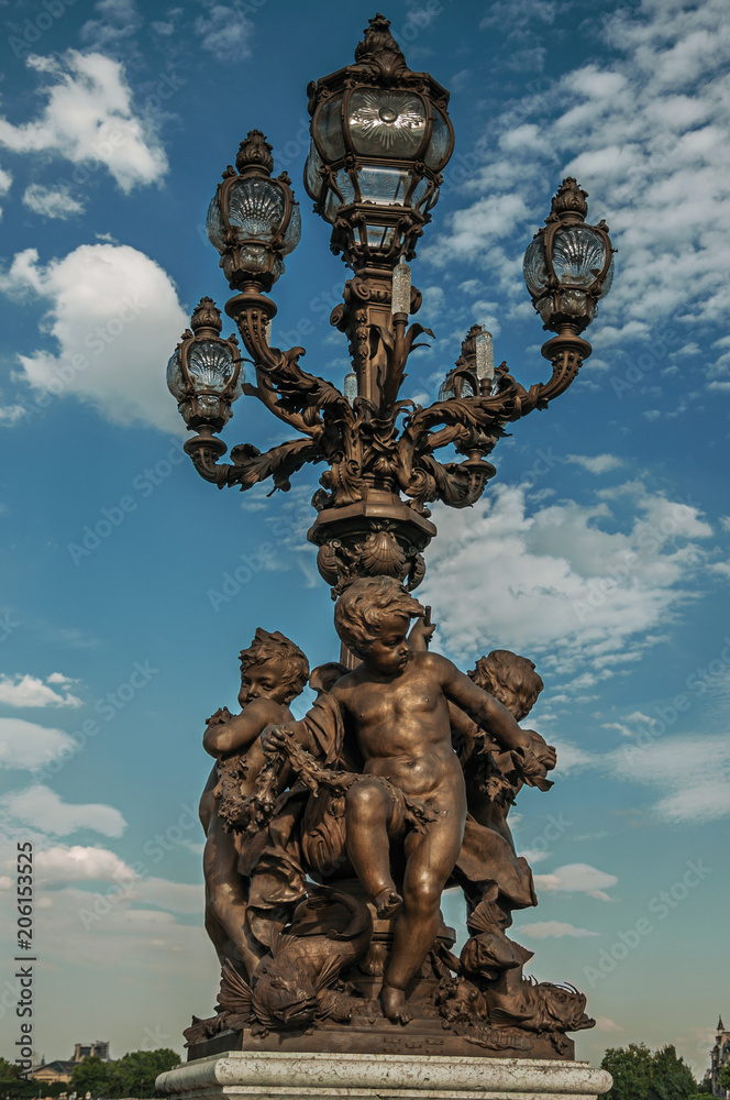 Fototapeta premium Close-up of the the lavishly decorated lamp on the Alexandre III bridge at the Seine river in Paris. Known as the “City of Light”, is one of the most awesome world’s cultural center. Northern France