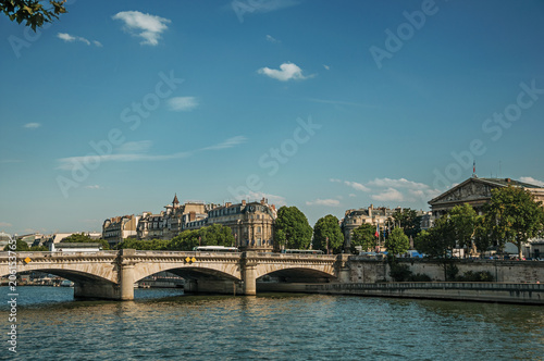 Buildings, trees and bridge of La Concorde on the Seine River at sunset in Paris. Known as the “City of Light”, is one of the most impressive world’s cultural center. Northern France.