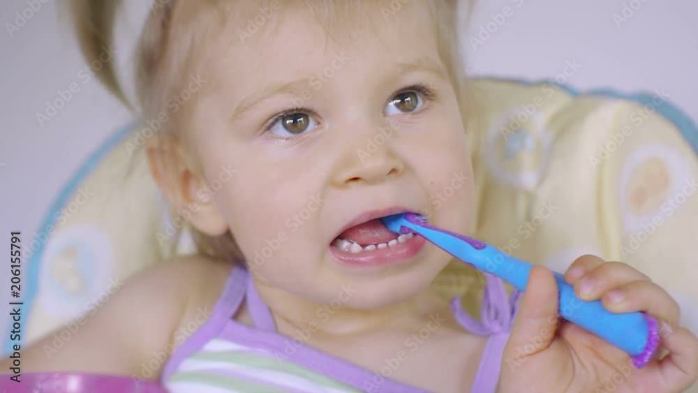Little girl diligently brushing his teeth Little girl diligently brushing his teeth