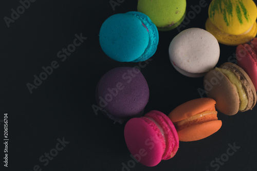 Macaroons on dark background, colorful french cookies macaroons.