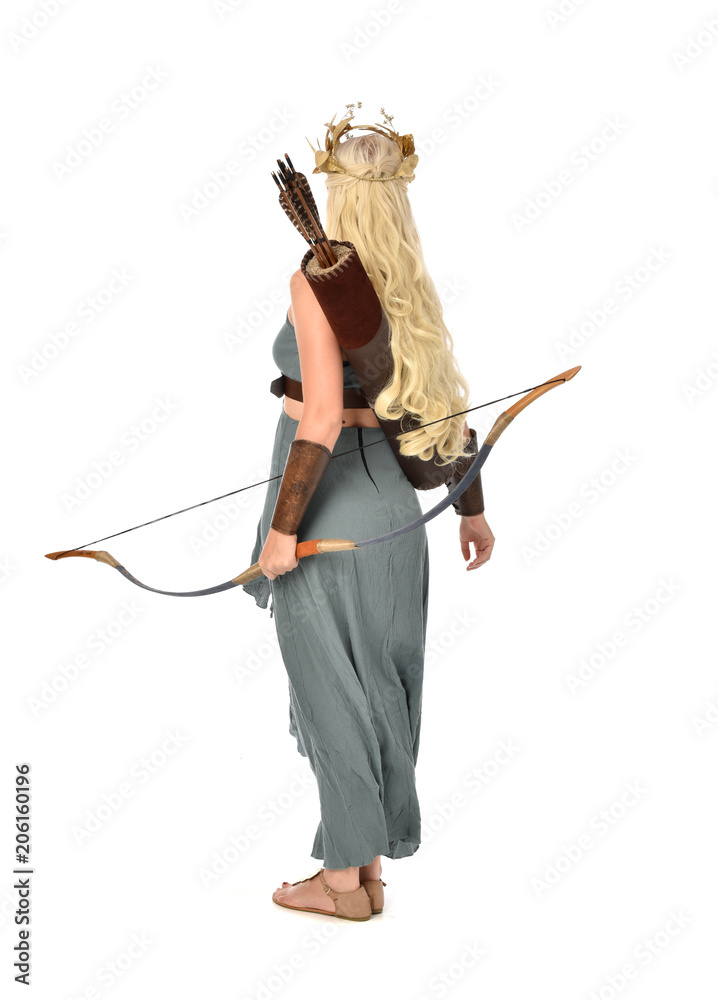 full length portrait of pretty blonde lady wearing fantasy toga gown, and holding a bow and arrow. standing pose on white background. full length portrait of pretty blonde lady wearing fantasy toga gown, and holding a bow and arrow. standing pose on white background.